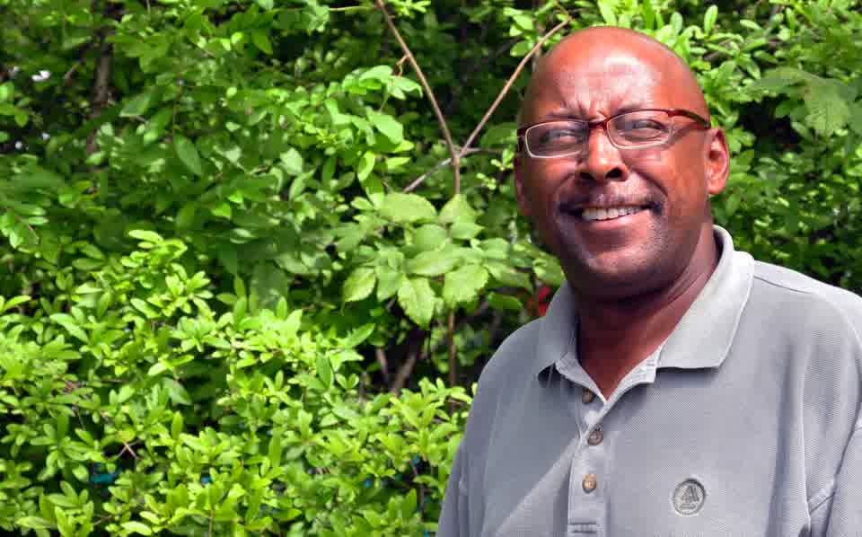 Greg Jones smiling in a garden